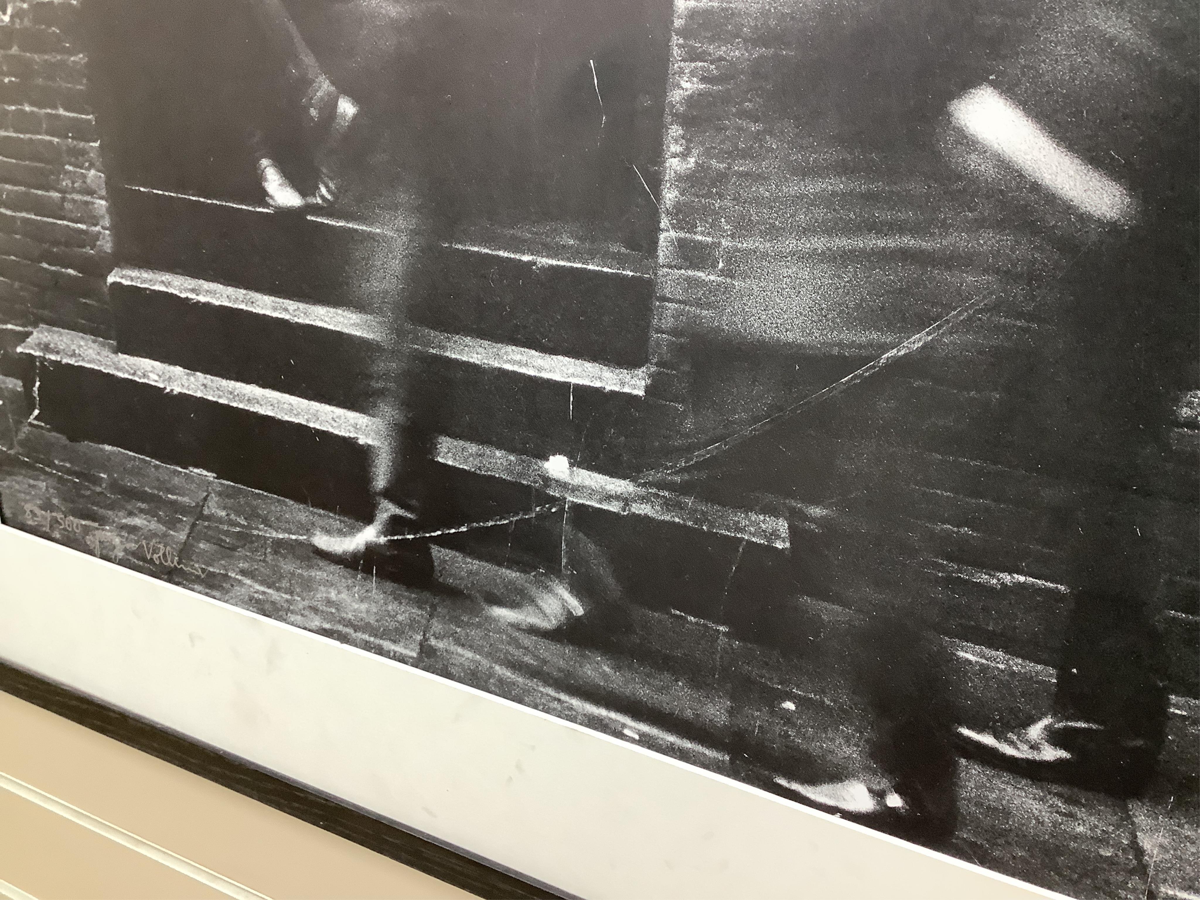 Jurgen Vollmer (German, b.1939), a framed signed limited edition lithograph 83/500 of John Lennon standing in a doorway in Hamburg (glass missing), 79 x 59cm